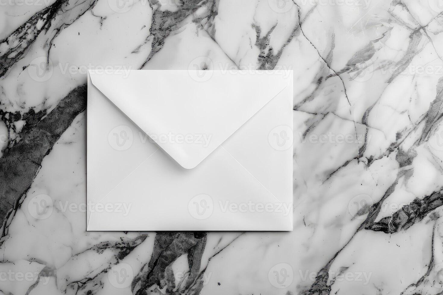 White blank envelope on gray marble table background. Top view photo