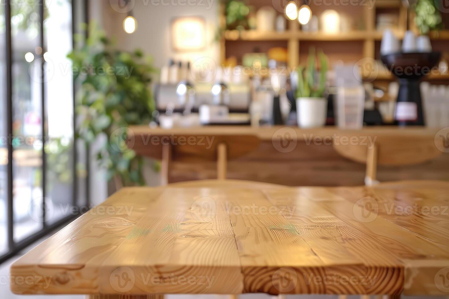 Modern co-working building relaxation lounge are or spacious bright cafe. Closeup to wooden table with chairs and blurred background with cafe area and barista serving organic drinks photo