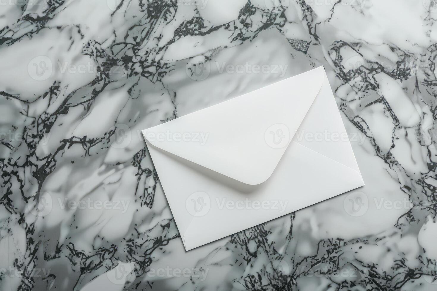 White blank envelope on gray marble table background. Top view photo