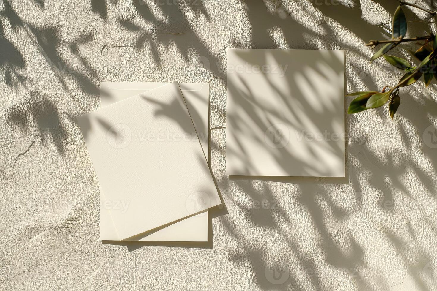 Flat lay of two rectangular blank cards and white envelope on ivory background with shadows. Top view photo