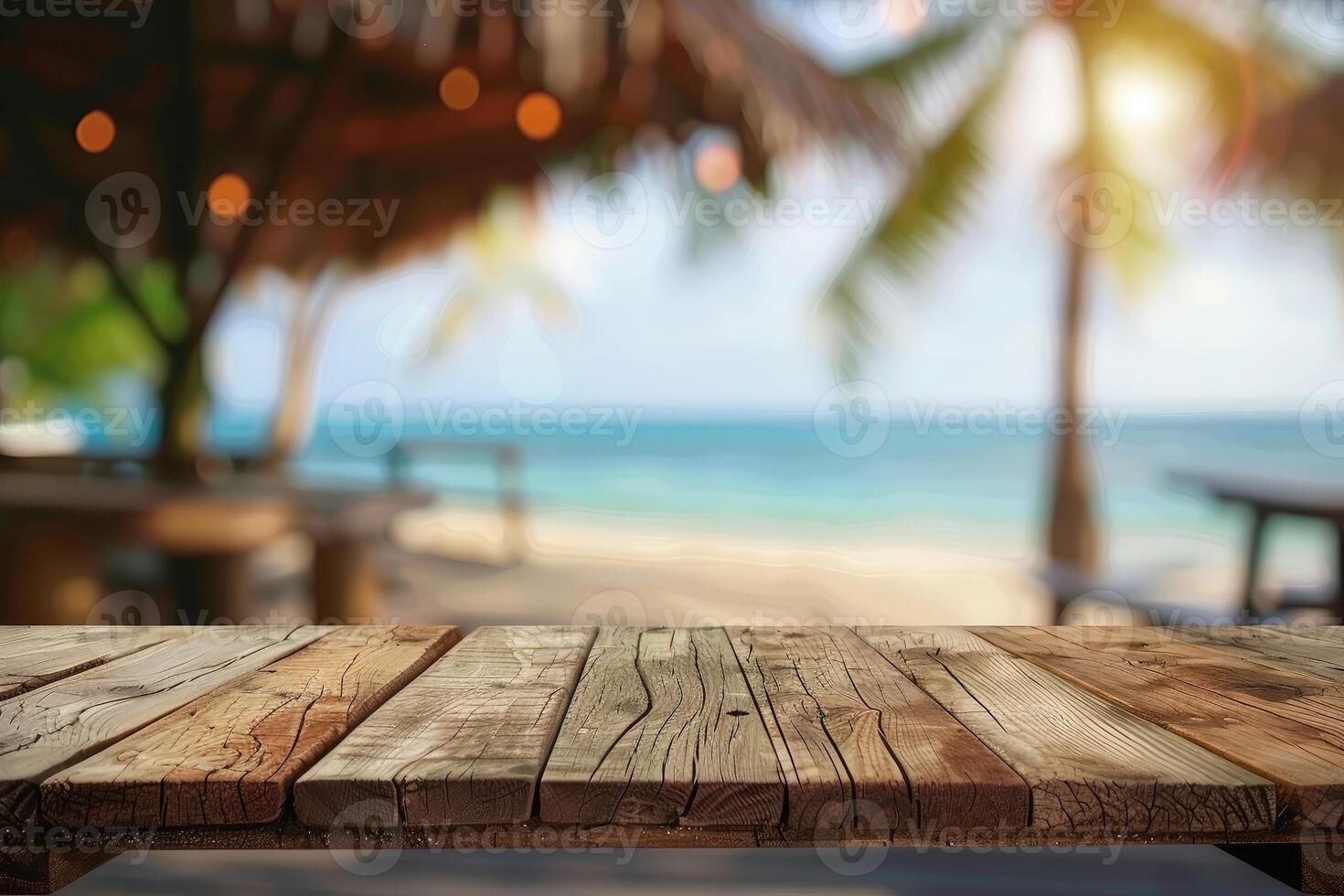 Empty wooden table top with copy space for food drink product advertising with blurred summer resort beach bar restaurant background photo