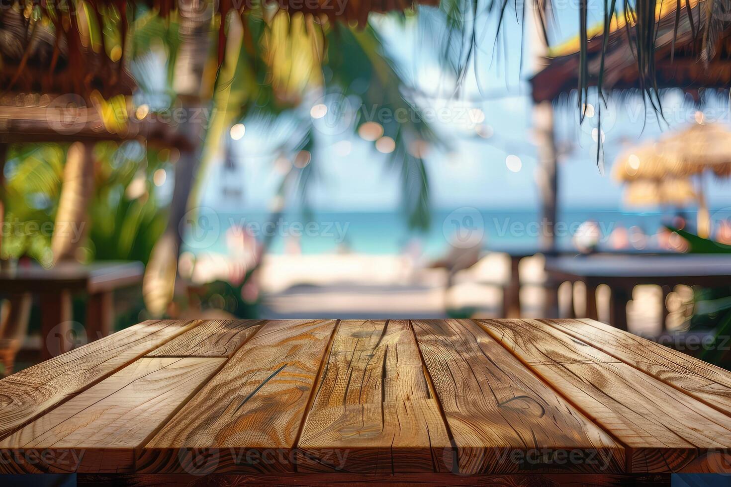 Empty wooden table top with copy space for food drink product advertising with blurred summer resort beach bar restaurant background photo