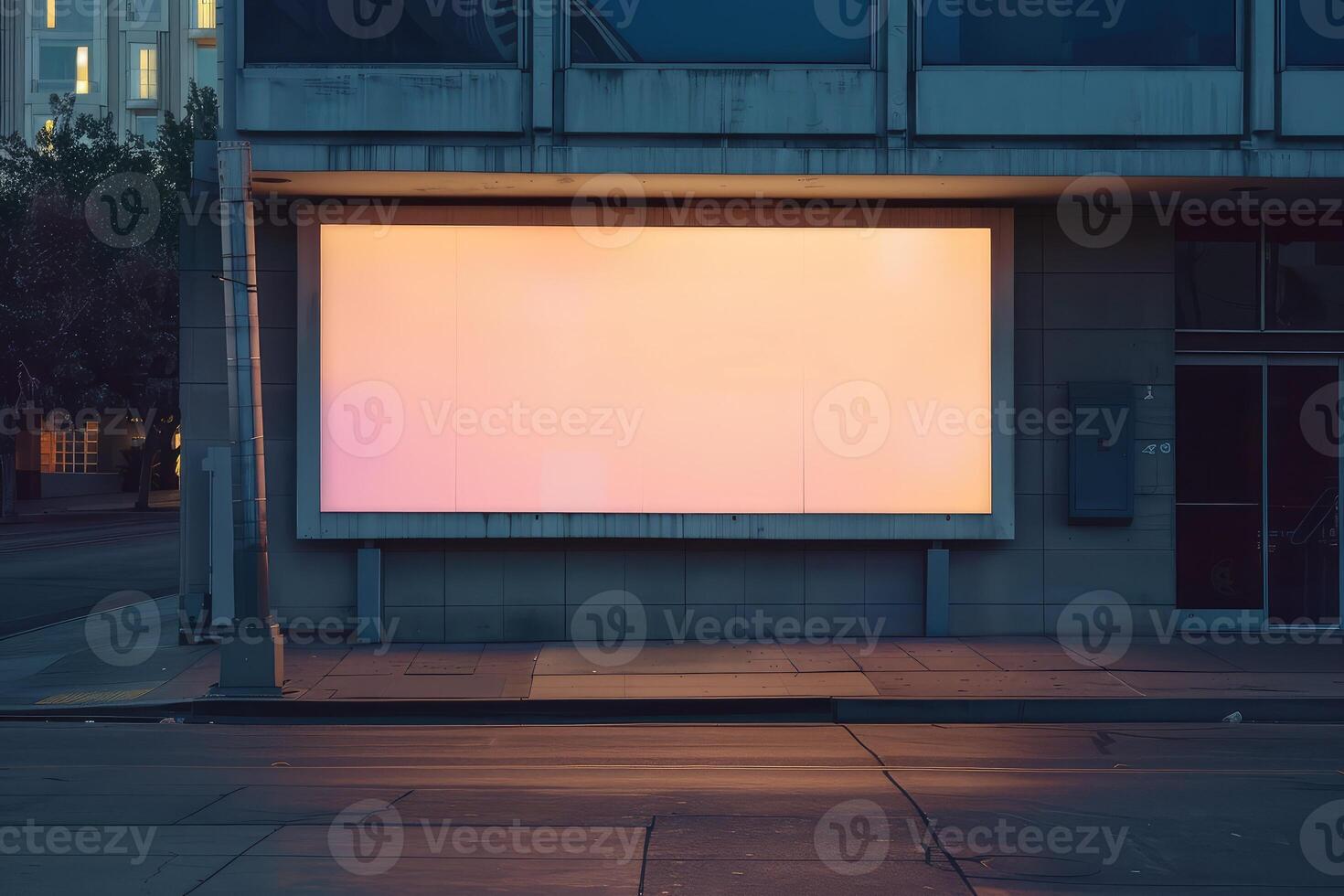 An empty billboard on a building exterior for mockup advertisement, at dusk with a lit interior backdrop photo