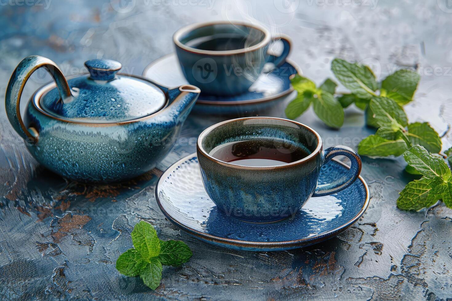 A blue tea set with cups and pot, fresh mint leaves, and concept of a health ceremony on a textured surface photo