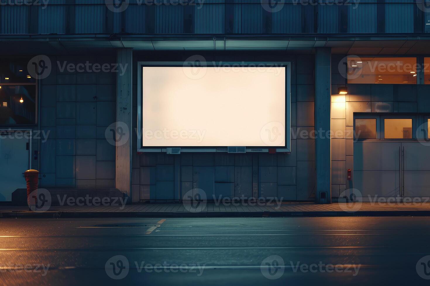 An empty billboard on a building exterior for mockup advertisement, at dusk with a lit interior backdrop photo