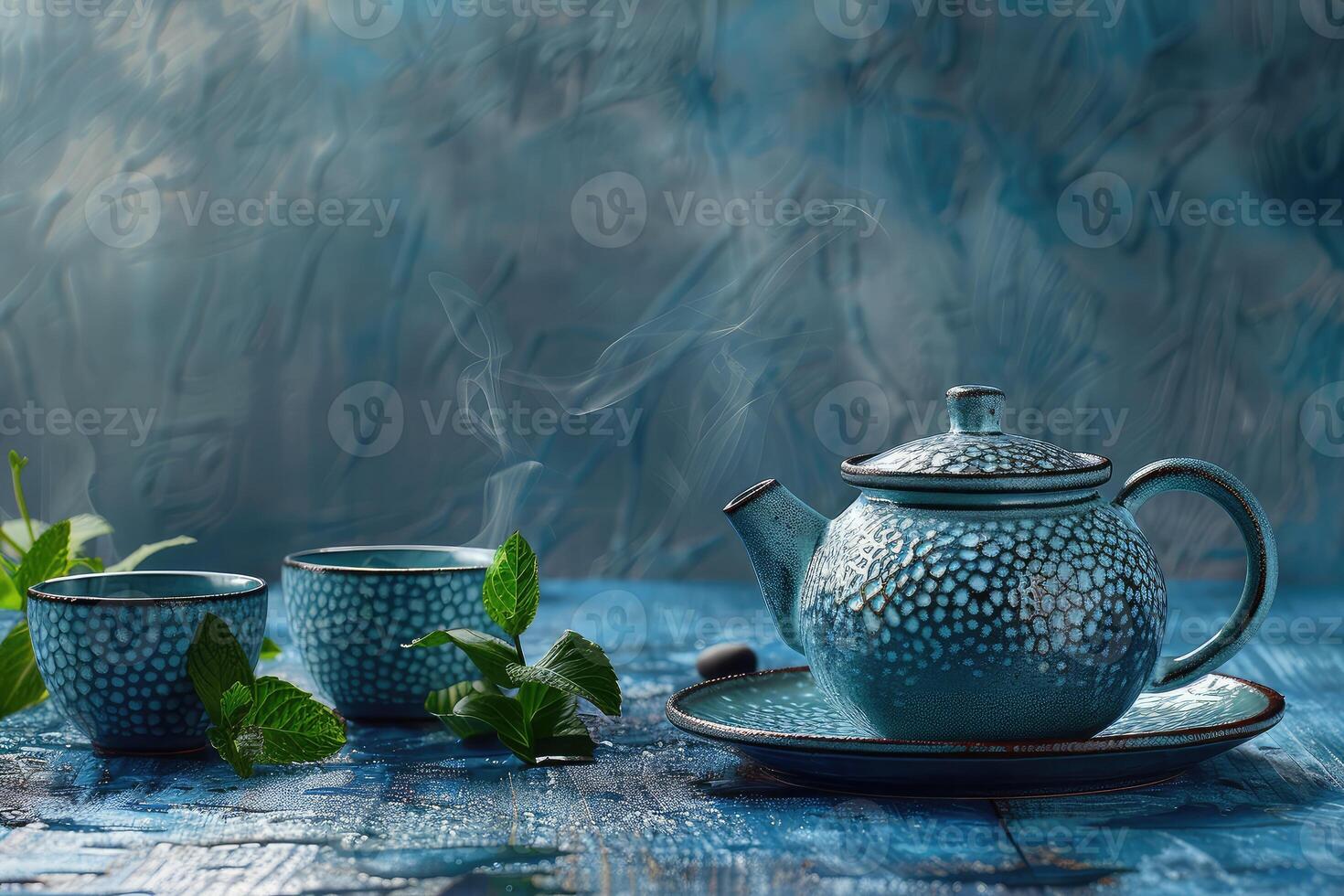 A blue tea set with cups and pot, fresh mint leaves, and concept of a health ceremony on a textured surface photo