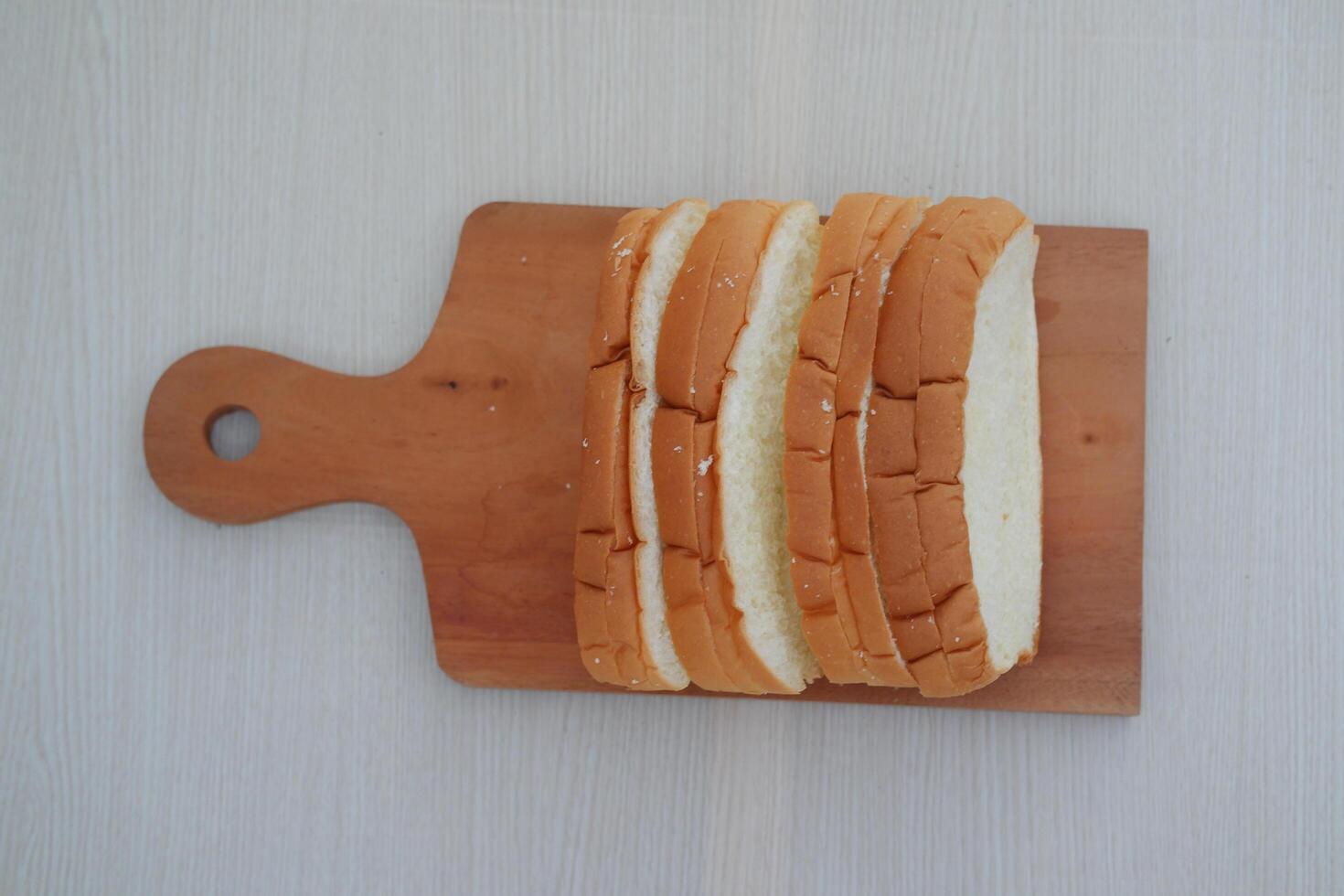 Sliced bread on a wooden cutting board photo