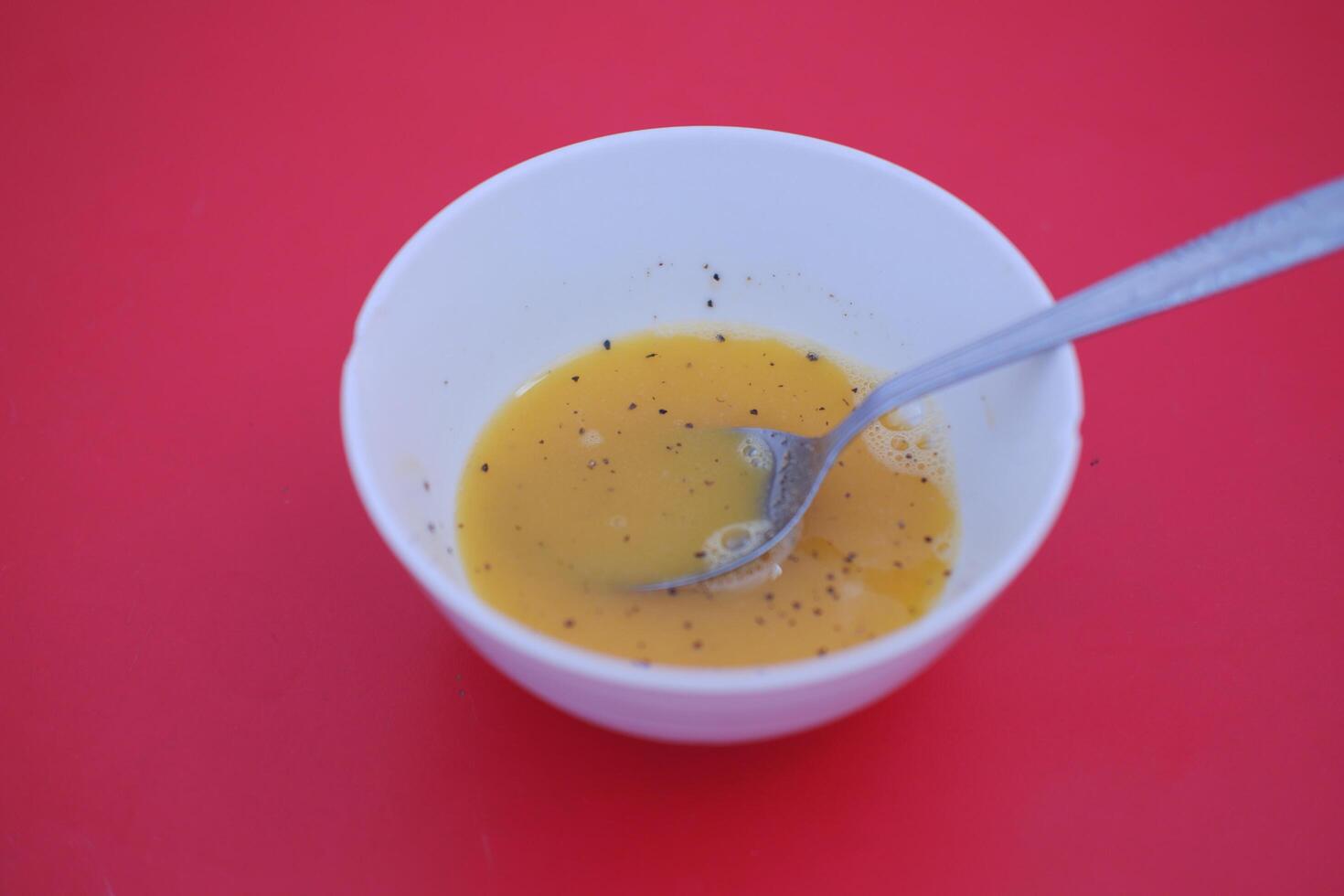 bowl with stirred raw eggs as a background photo