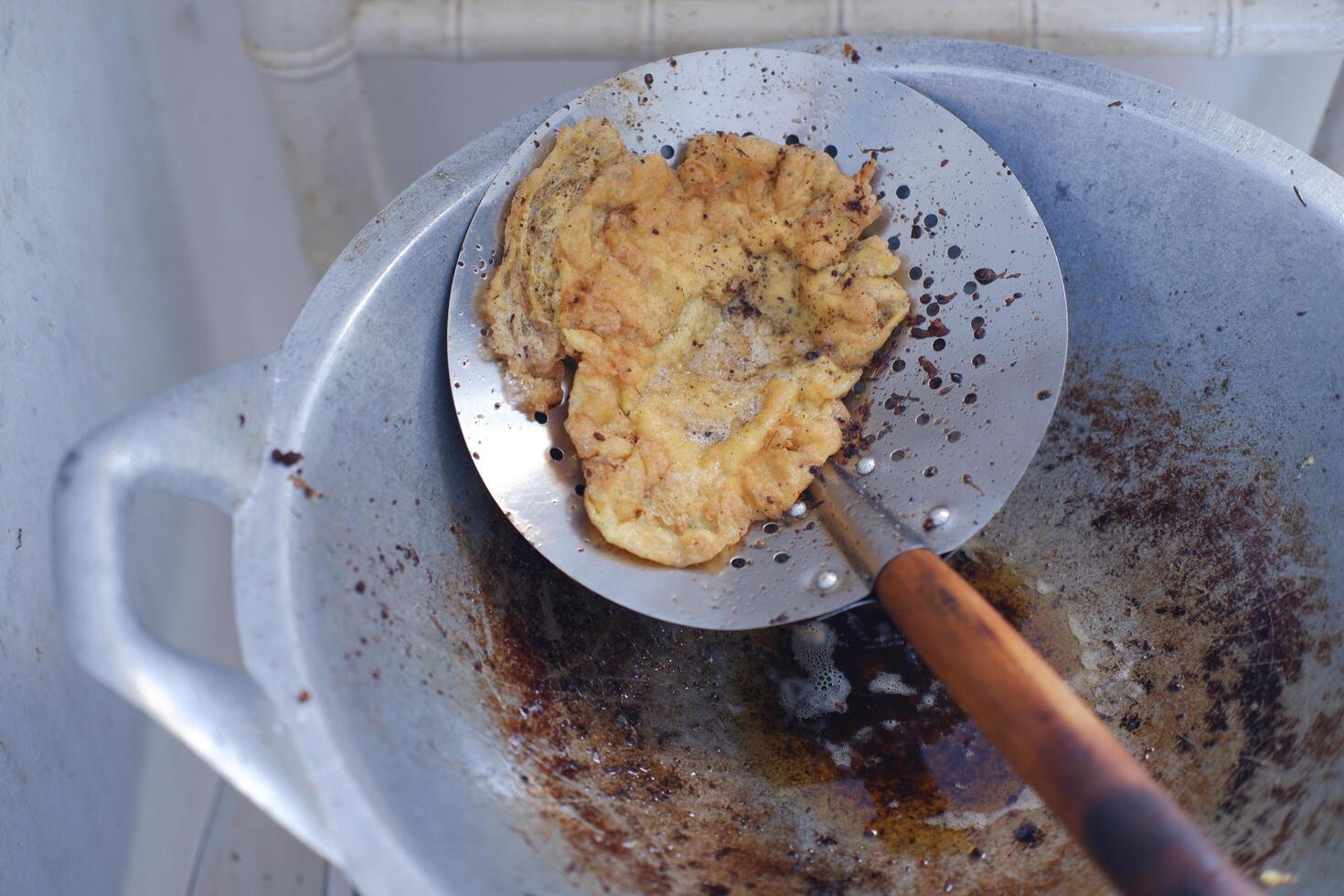 Fried omelet in a frying pan, close-up photo