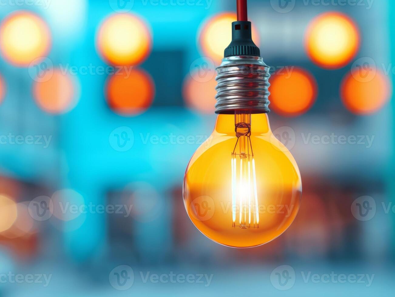 glowing light bulb with blurred bokeh background, inspiration and creativity concept. photo