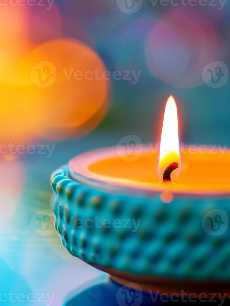 close-up of burning candle with bokeh background - teal and orange hues. photo