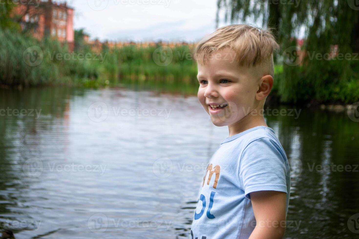 Small boy playing on a pond. photo