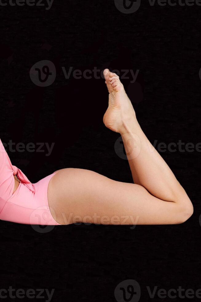 A fitness instructor demonstrates the starting position of the yoga bridge pose photo