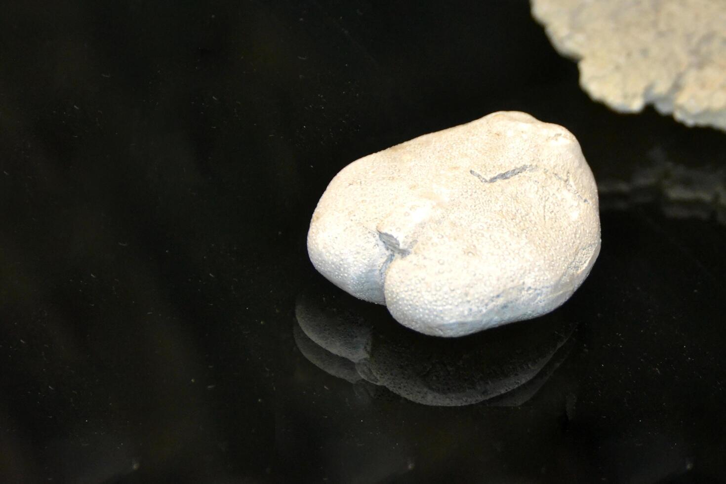 a large rock with a hole in it is floating in the air photo