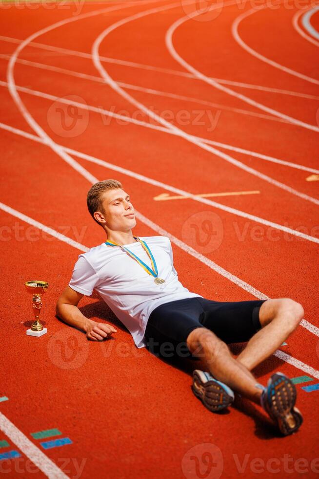 A track runner is standing at the starting line, getting ready for a quick sprint photo