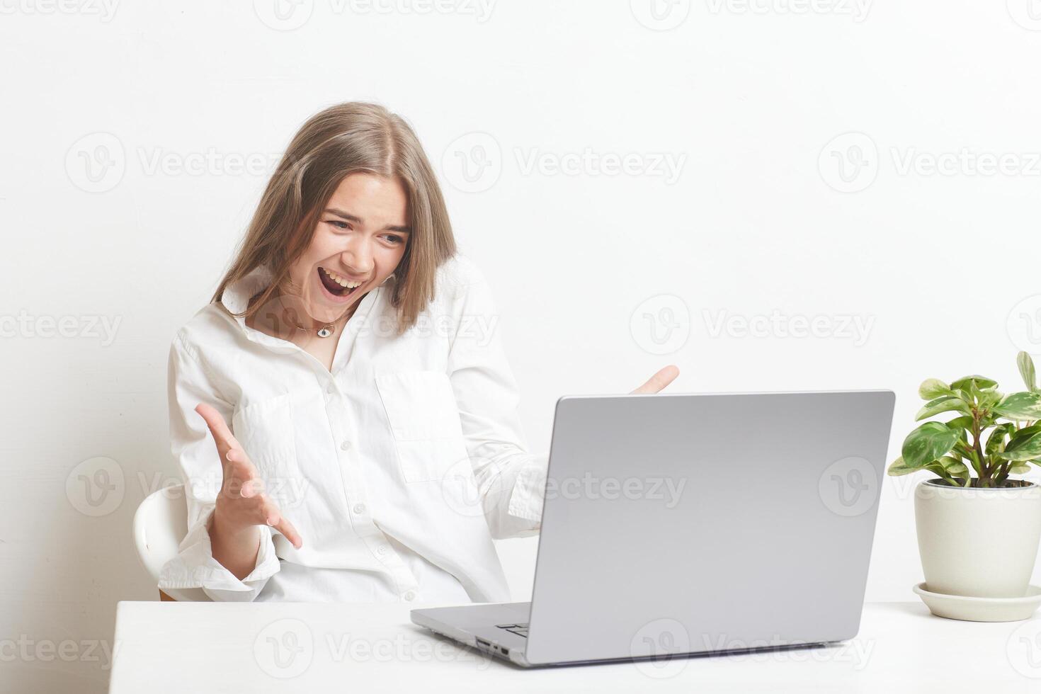 happy girl with laptop rejoices at successful work while working in the office, success at work photo
