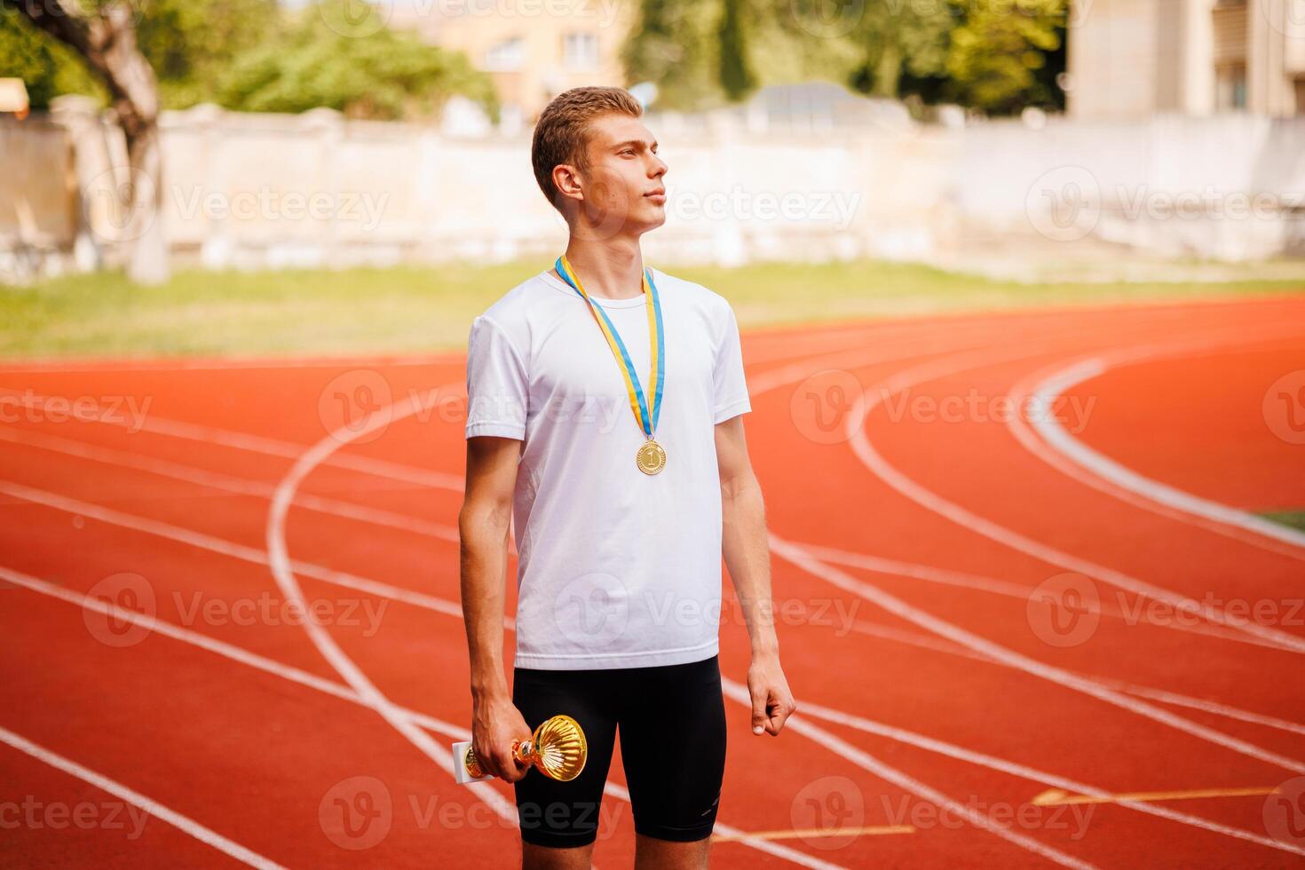 A track runner is standing at the starting line, getting ready for a quick sprint photo