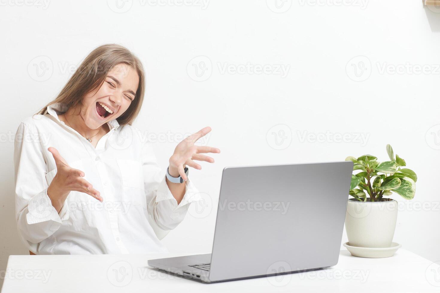 happy girl with laptop rejoices at successful work while working in the office, success at work photo