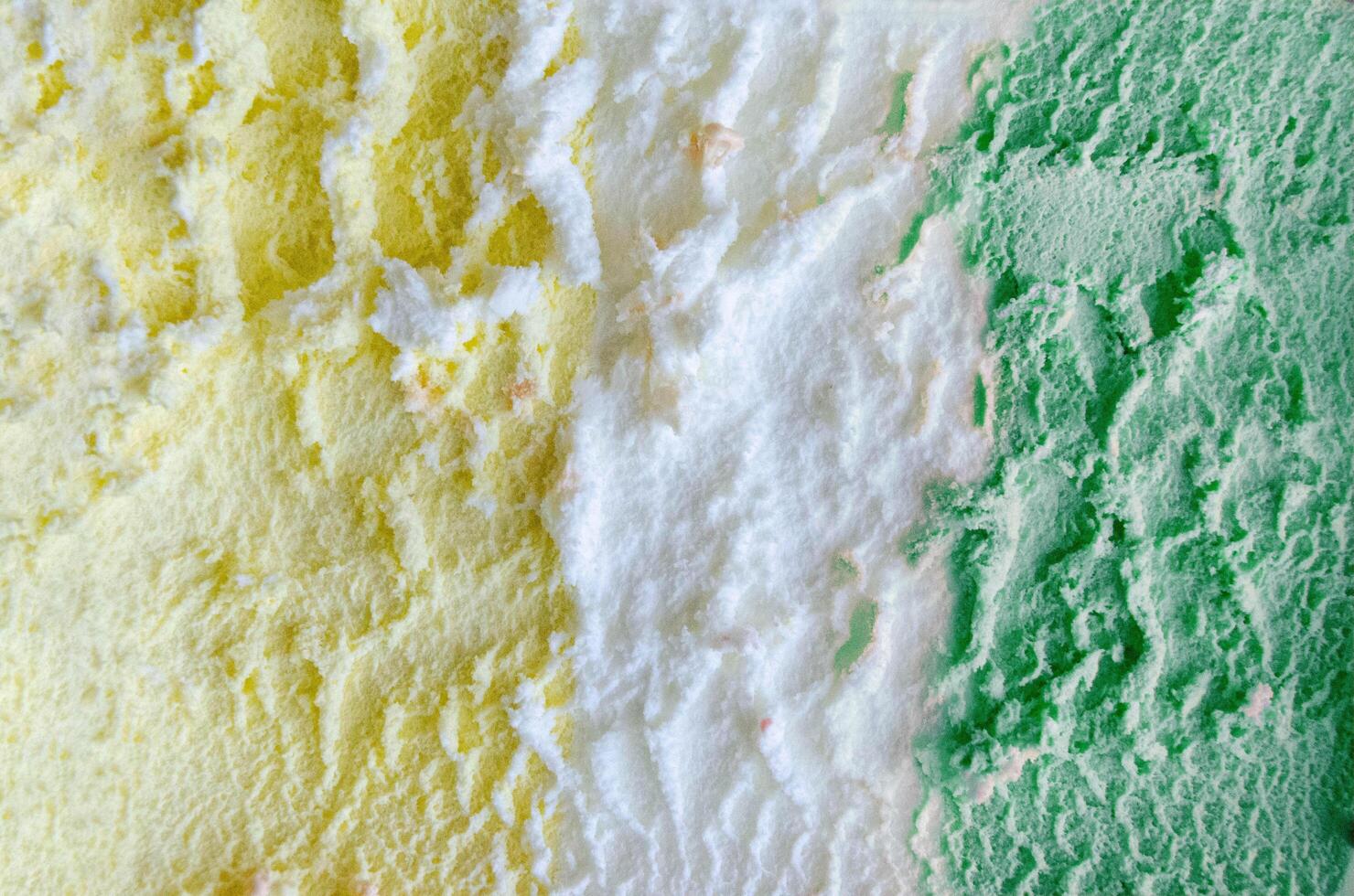 texture of yellow white and green ice cream like background, close up photo
