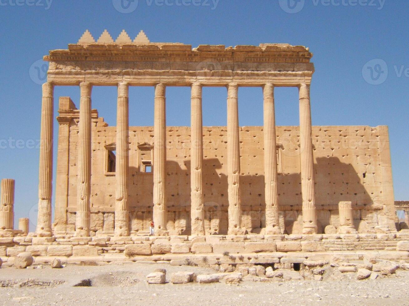 The Bel Temple in Palmyra, Syria, is an ancient architectural marvel. Majestic columns and intricate carvings adorn its facade, reflecting a blend of Roman and Semitic influences. The temple, dedicate photo