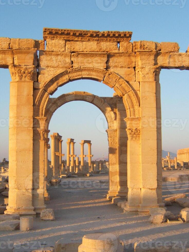 The Bel Temple in Palmyra, Syria, is an ancient architectural marvel. Majestic columns and intricate carvings adorn its facade, reflecting a blend of Roman and Semitic influences. The temple, dedicate photo