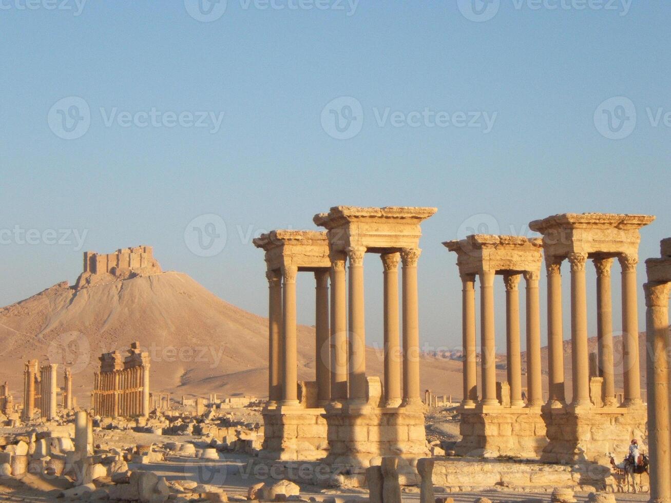 The Bel Temple in Palmyra, Syria, is an ancient architectural marvel. Majestic columns and intricate carvings adorn its facade, reflecting a blend of Roman and Semitic influences. The temple, dedicate photo