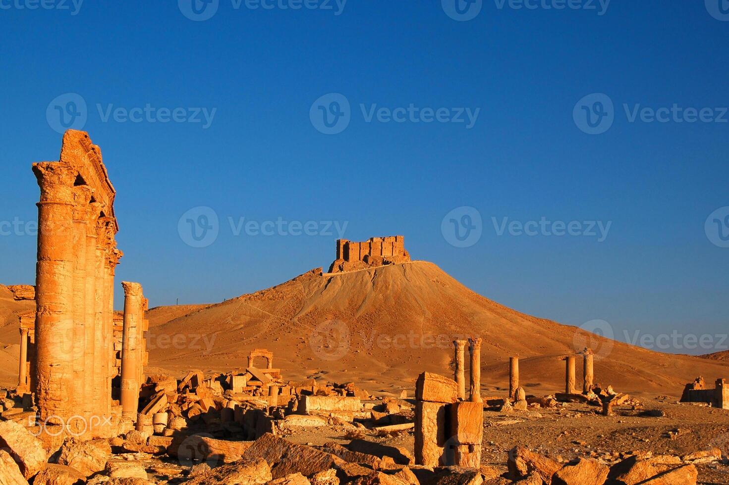The Bel Temple in Palmyra, Syria, is an ancient architectural marvel. Majestic columns and intricate carvings adorn its facade, reflecting a blend of Roman and Semitic influences. The temple, dedicate photo