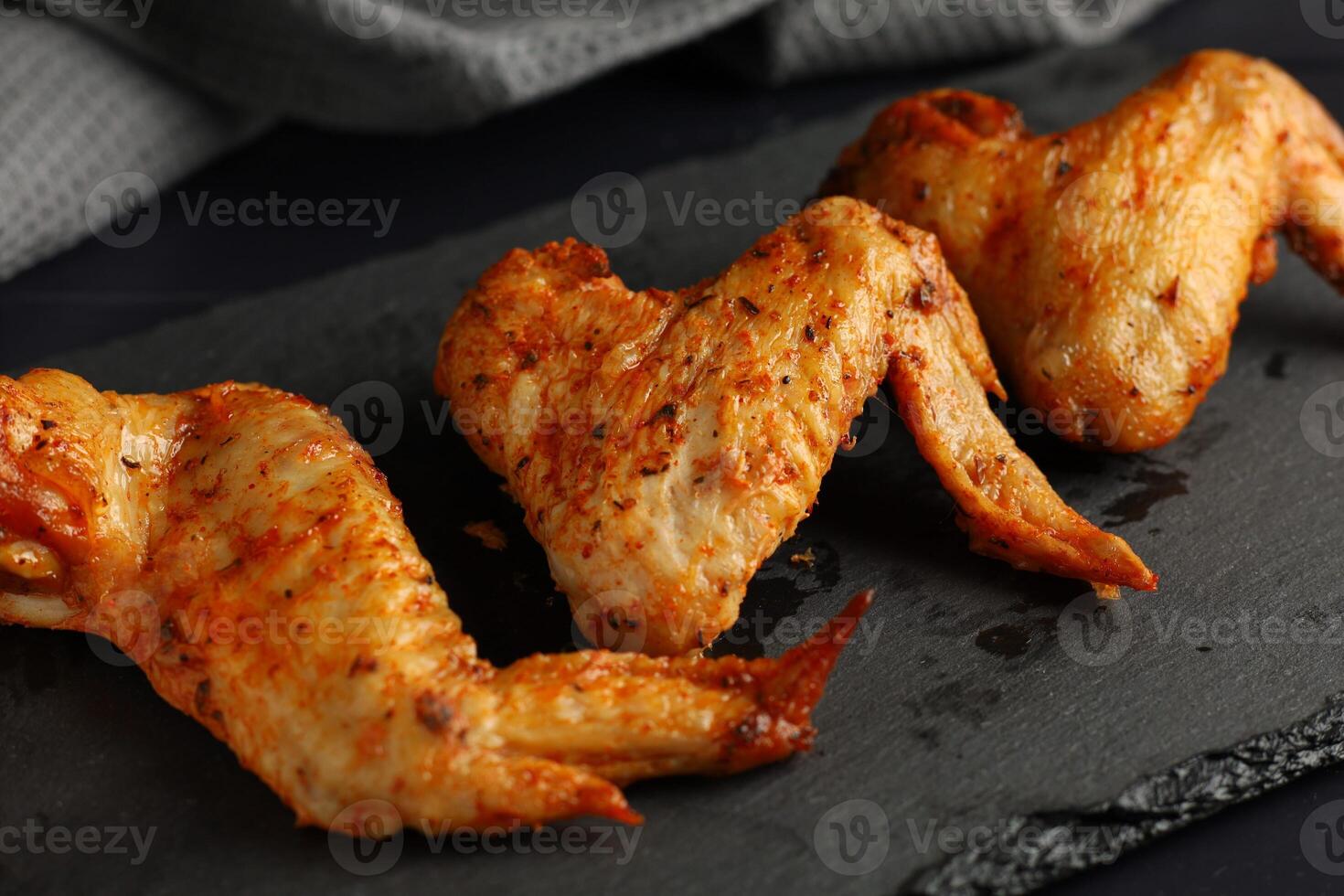 Bbq buffalo wings. Fried chicken on a dark background. delicious grilled chicken wings photo