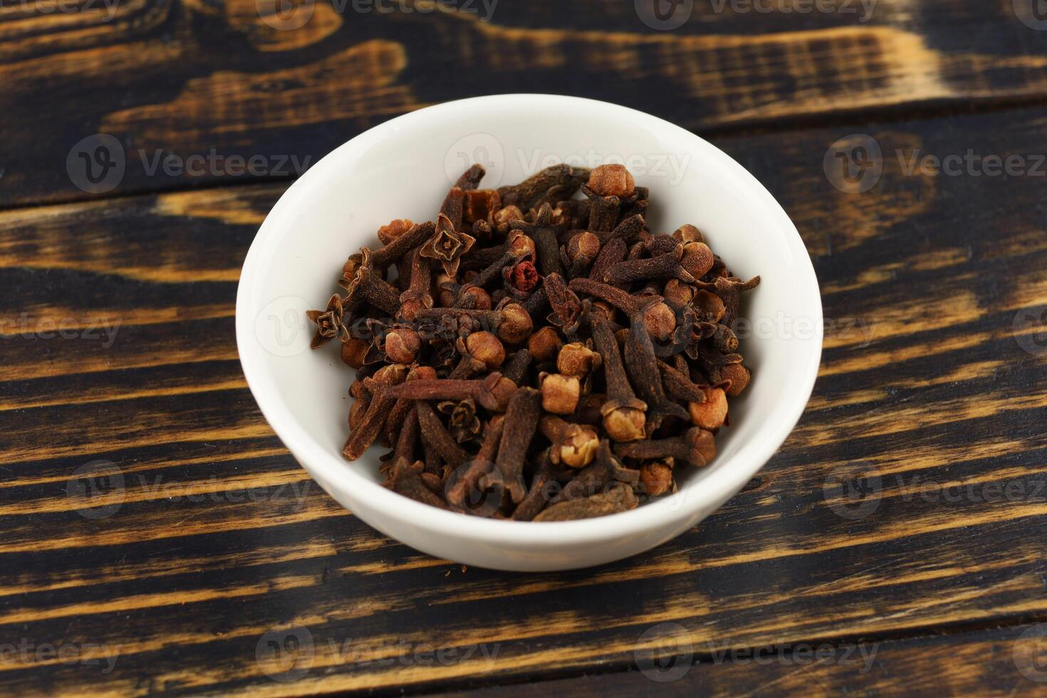 Clove spice in a white ceramic vessel photo