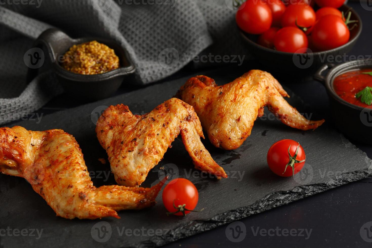 Chicken wings with vegetables and herbs. Hot and Spicy Buffalo Wings photo