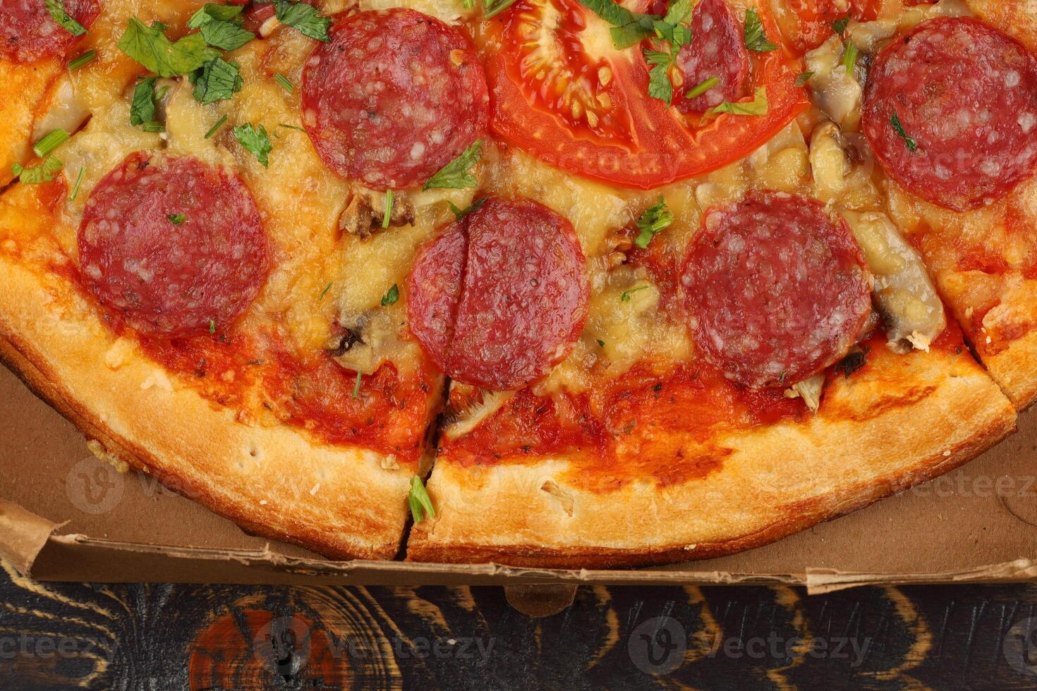 Pizza with sausage close-up. Pizza with Mozzarella cheese, salami, pepper. photo