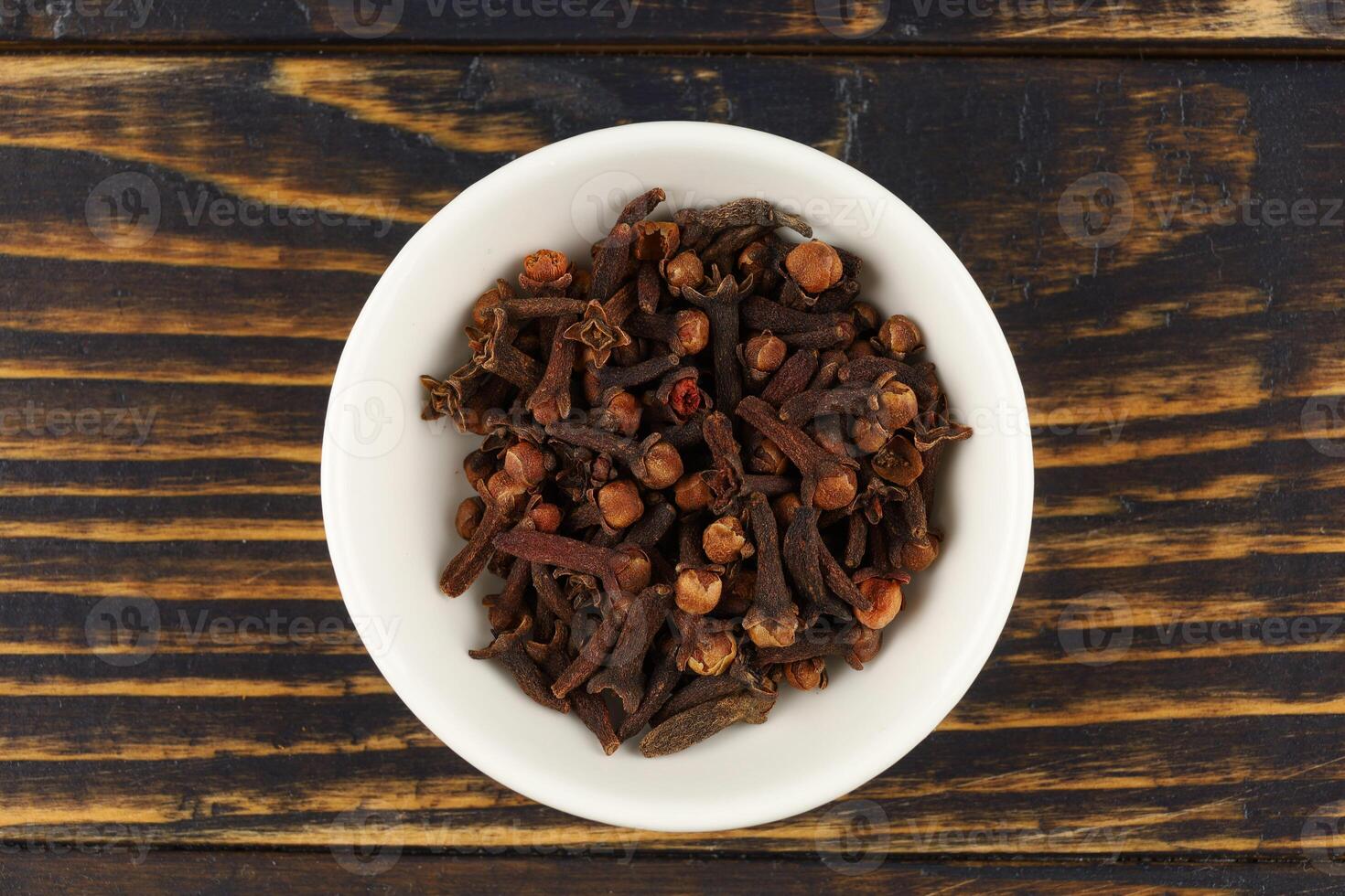 Clove spice in a white ceramic vessel photo