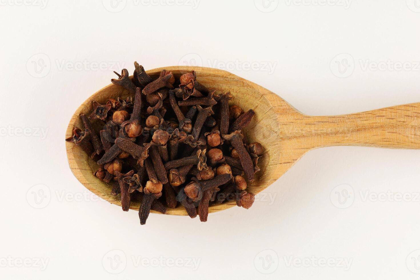 Clove spice in a wooden spoon photo