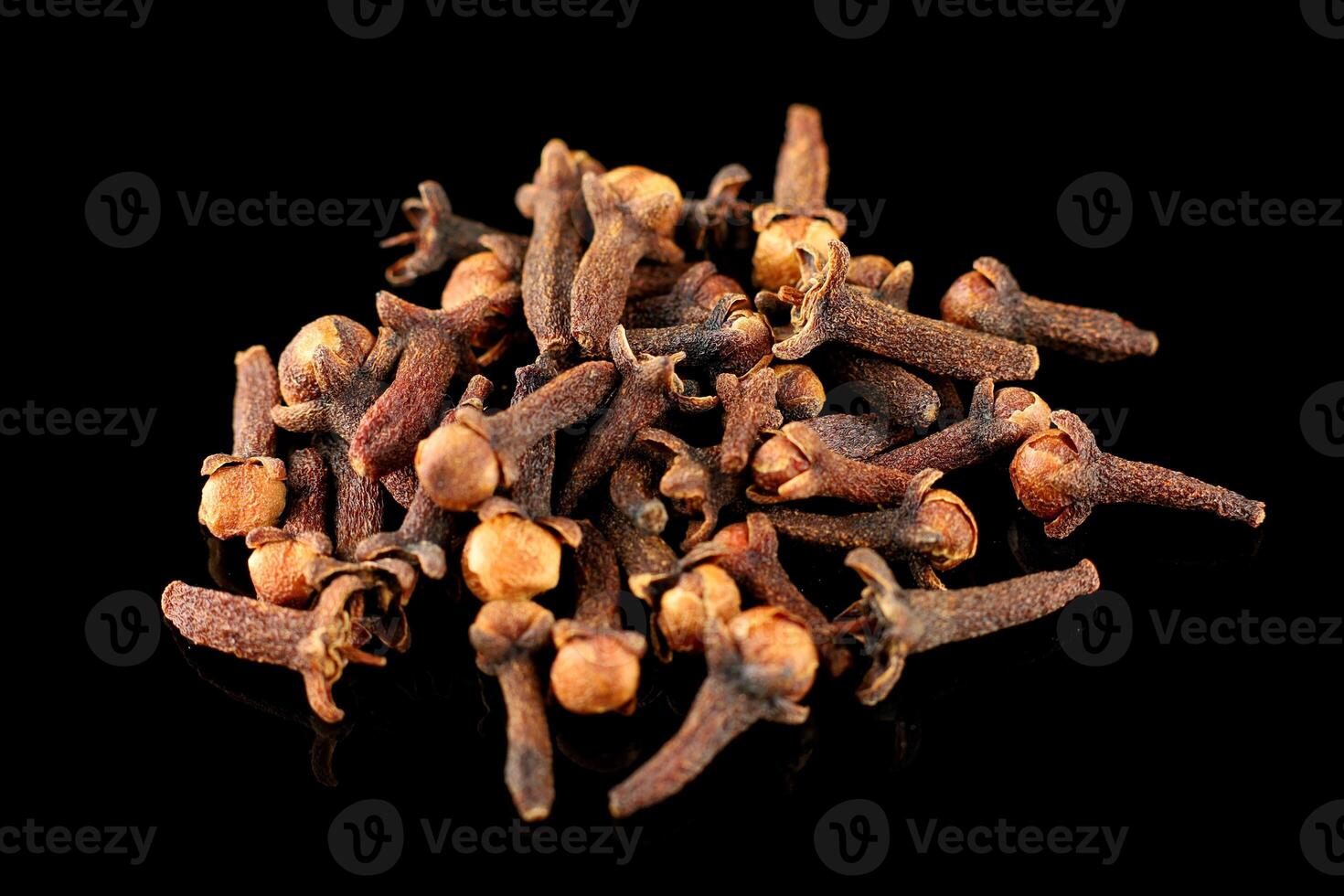 Clove spice pile on black isolate photo