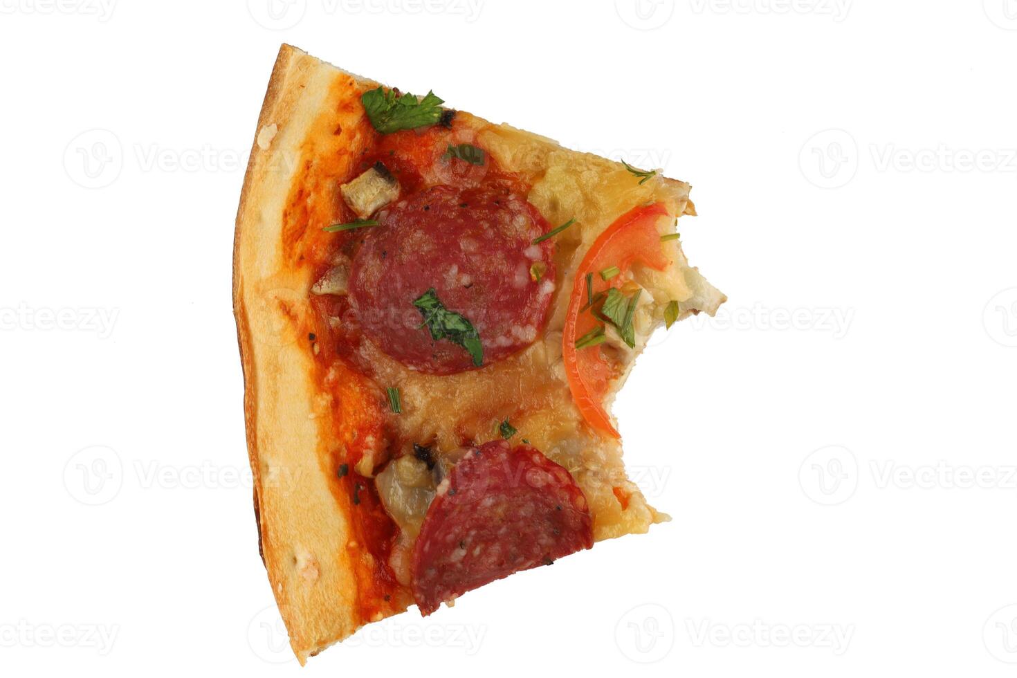A piece of pizza is bitten. Pizza with salami and tomatoes isolate. photo