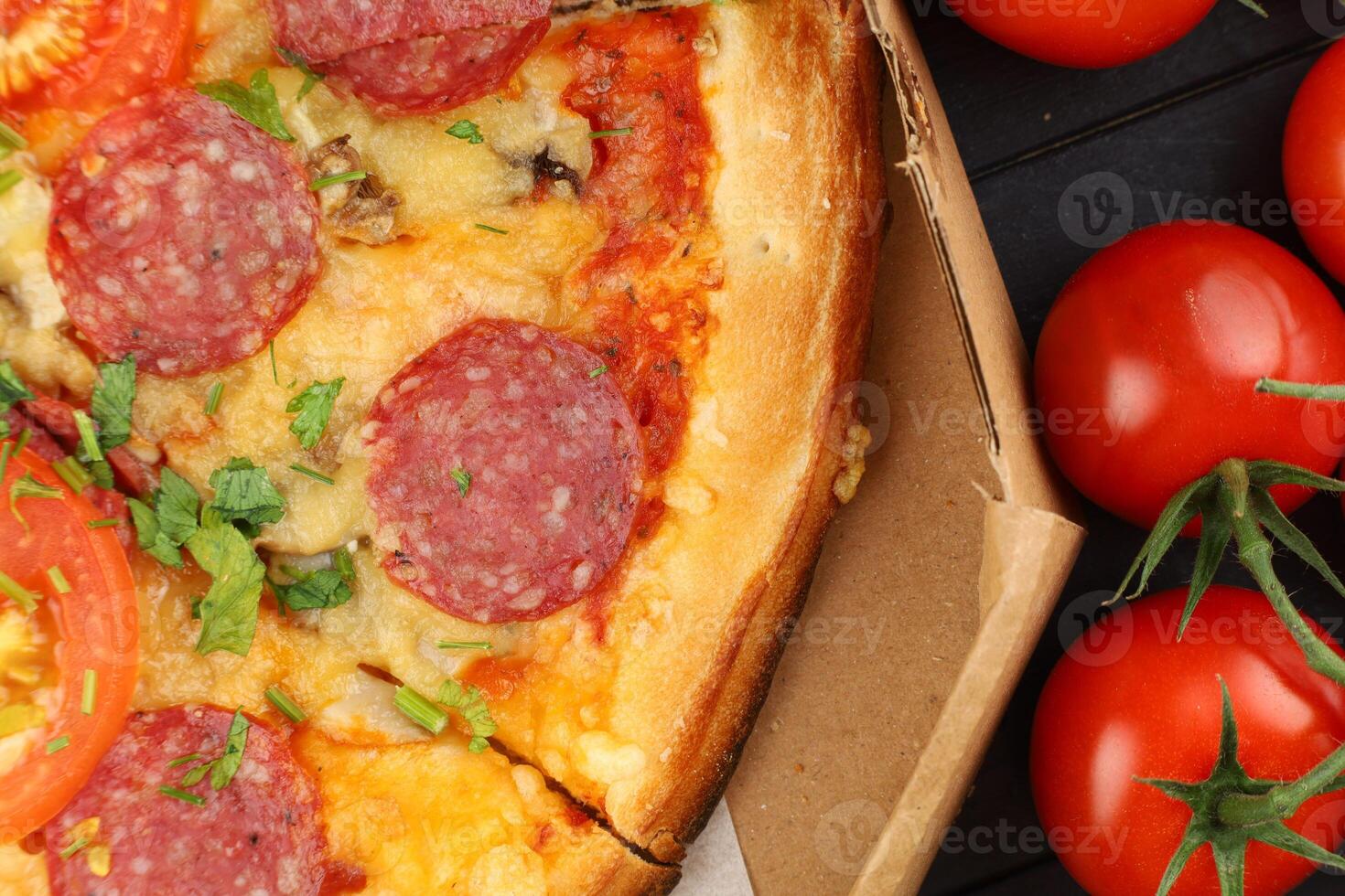 Pizza in a box on the table. Hot pizza with vegetables. Pizza in a restaurant. photo