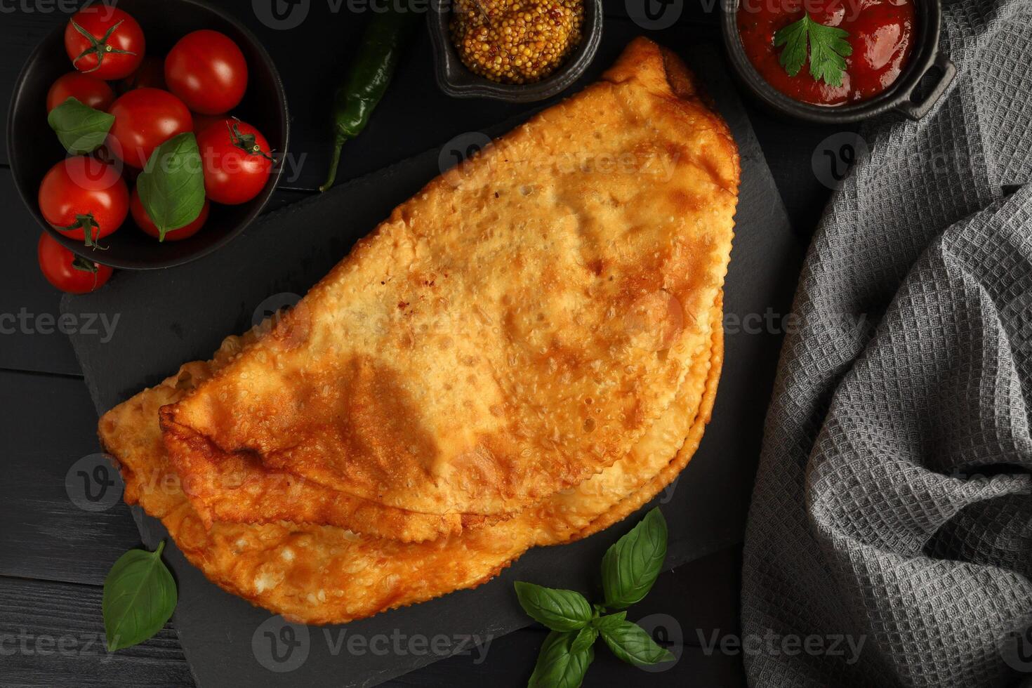 Chebureks with meat. Fried in oil chebureks with meat and herbs. Street food photo
