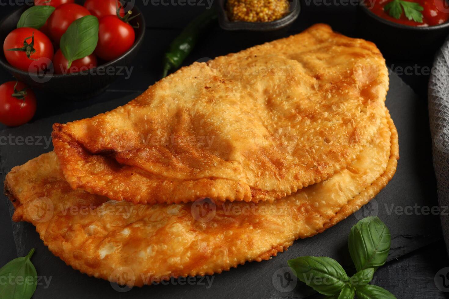 Chebureks with meat. Fried in oil chebureks with meat and herbs. Street food photo