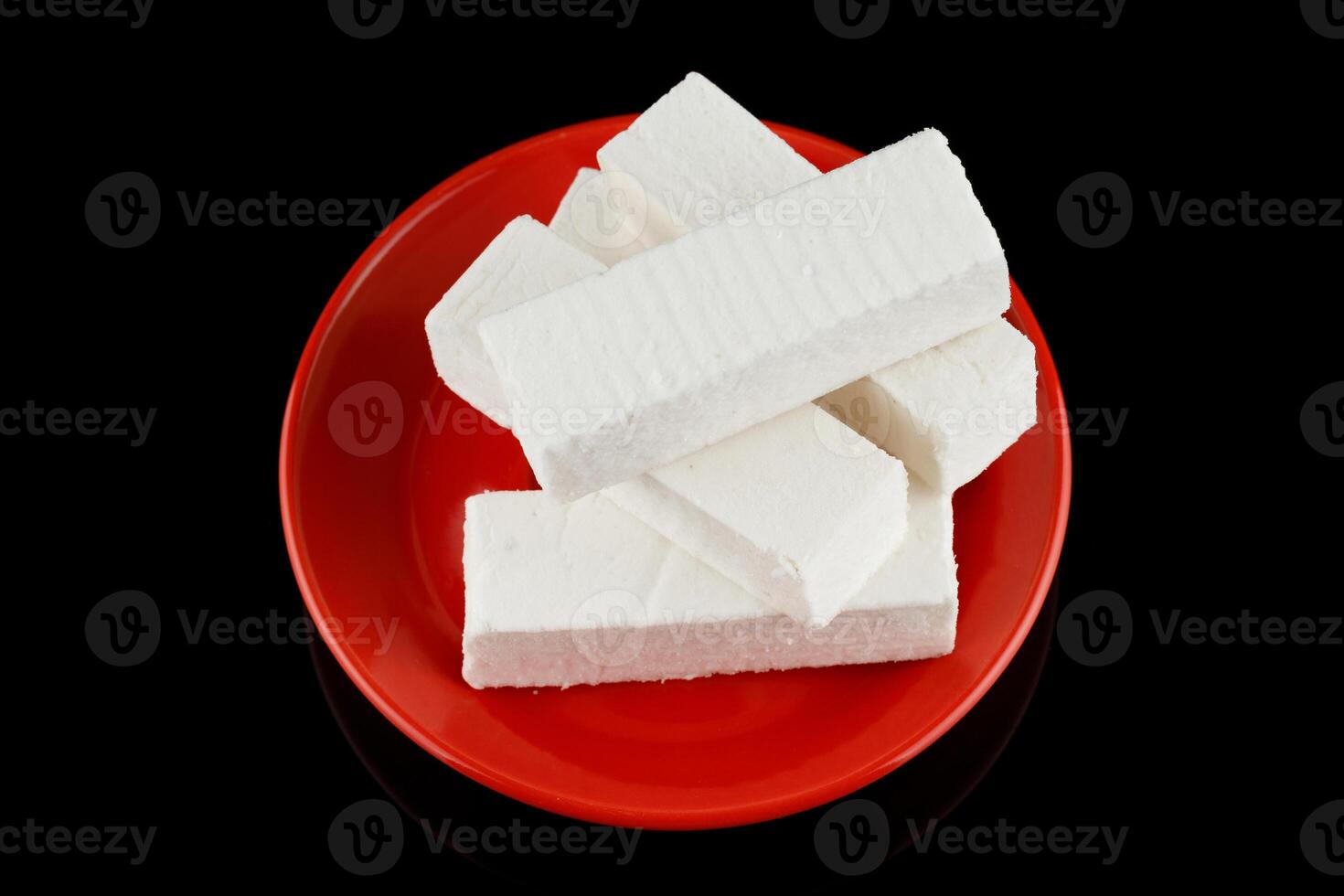 Pastilla white confectionery product on black. photo