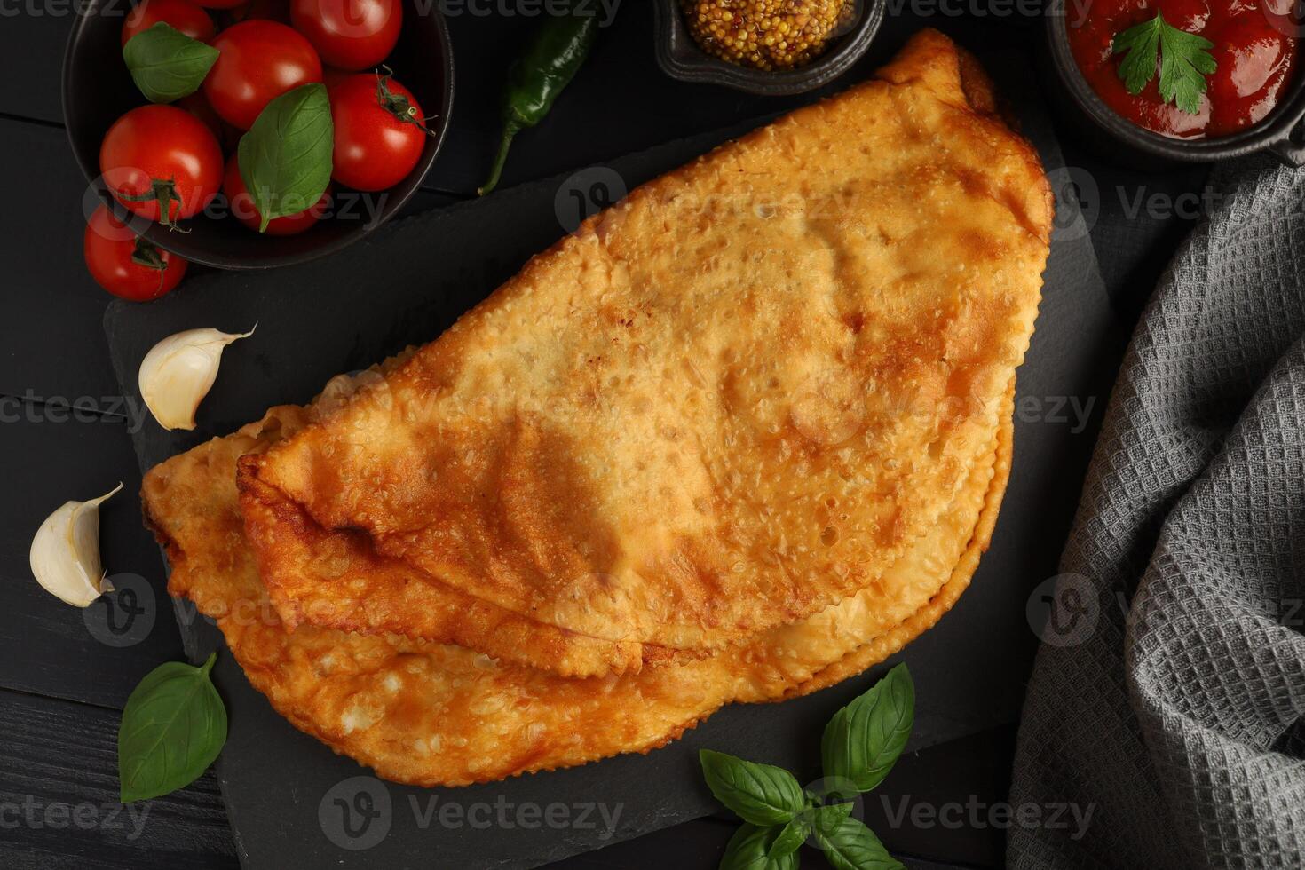 Chebureks with meat. Fried in oil chebureks with meat and herbs. Street food photo