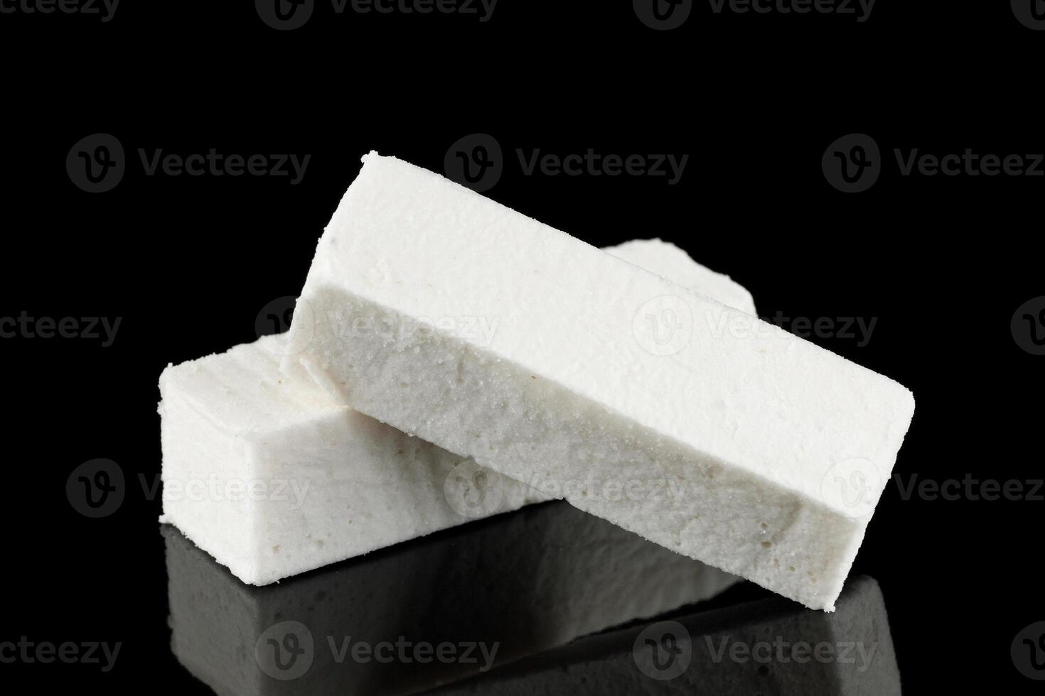 Pastilla white confectionery product on black. photo