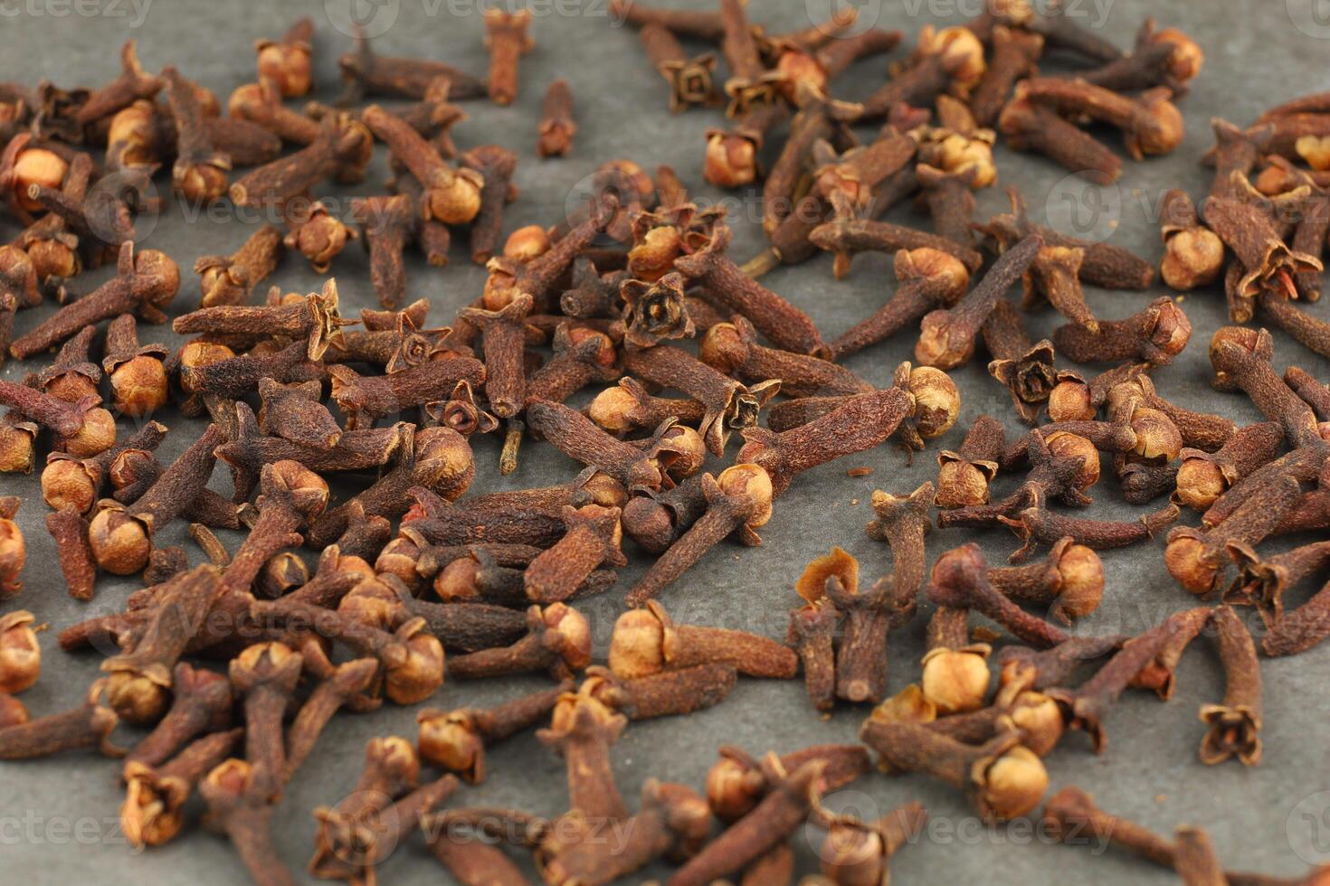 Clove spice heap on a gray background photo