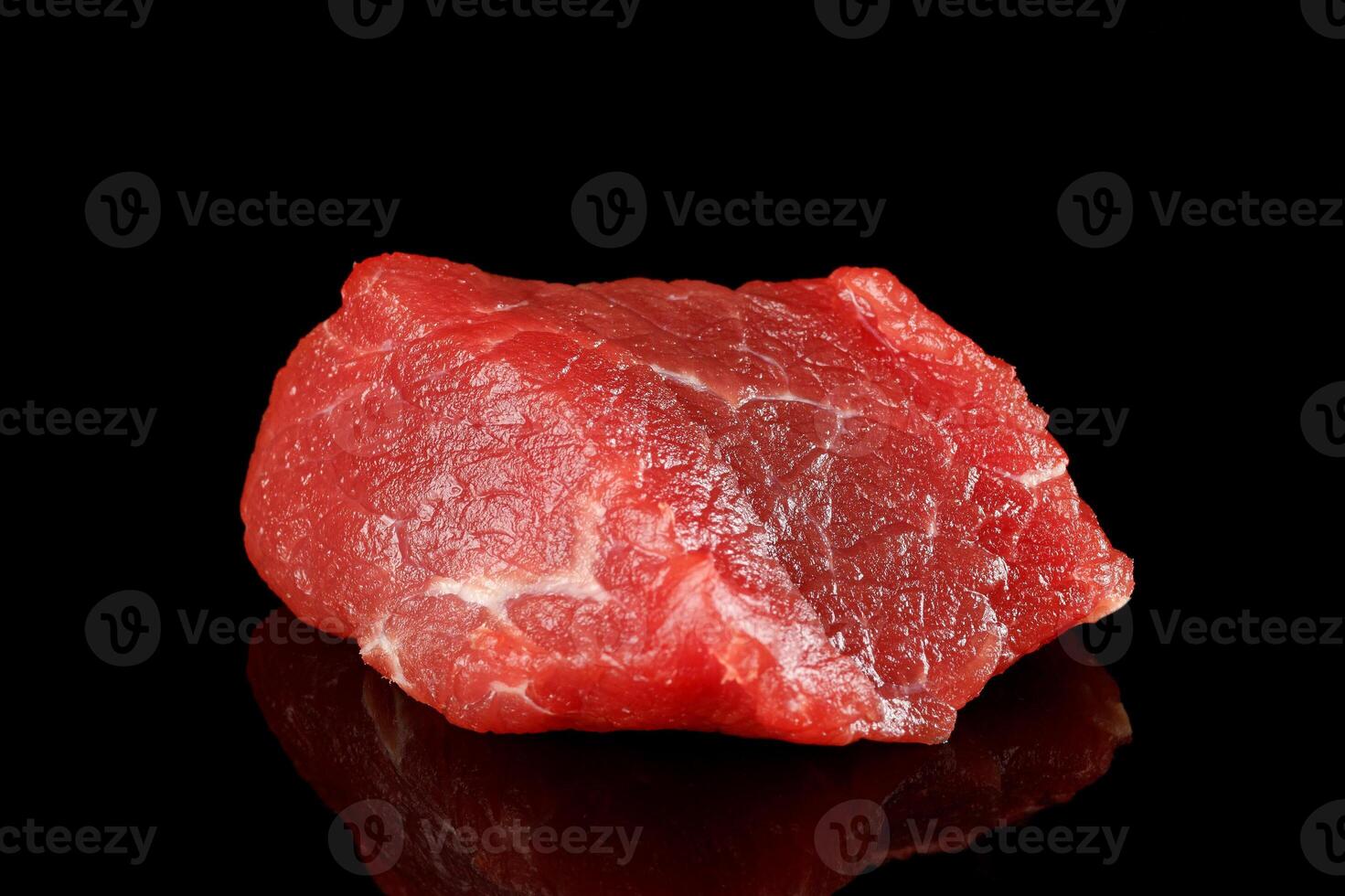 A piece of red raw meat. Meat on black isolate. meat pork on a black background. piece of fresh raw meat photo