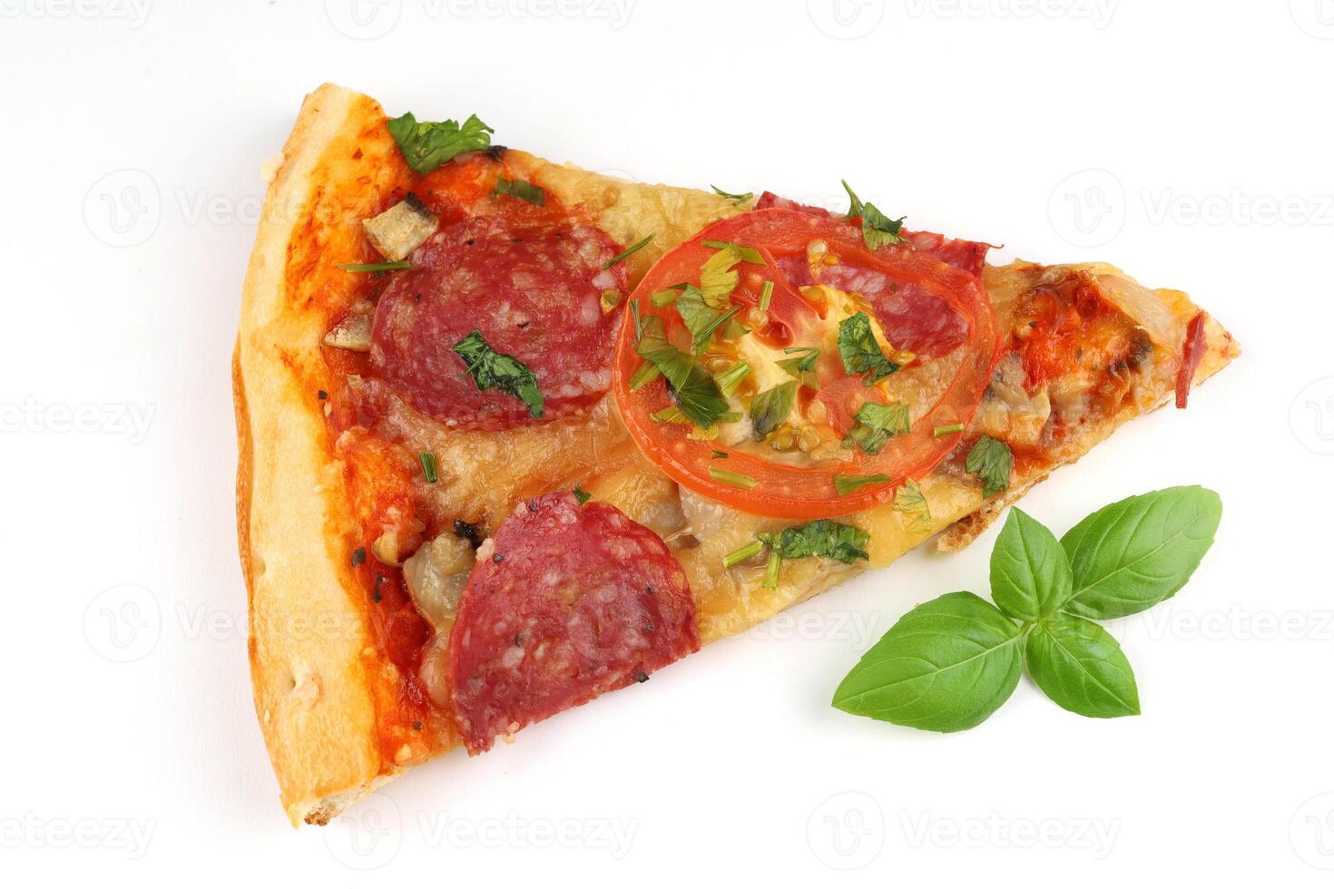 Sliced pizza on white isolate. Pizza and fresh basil. photo