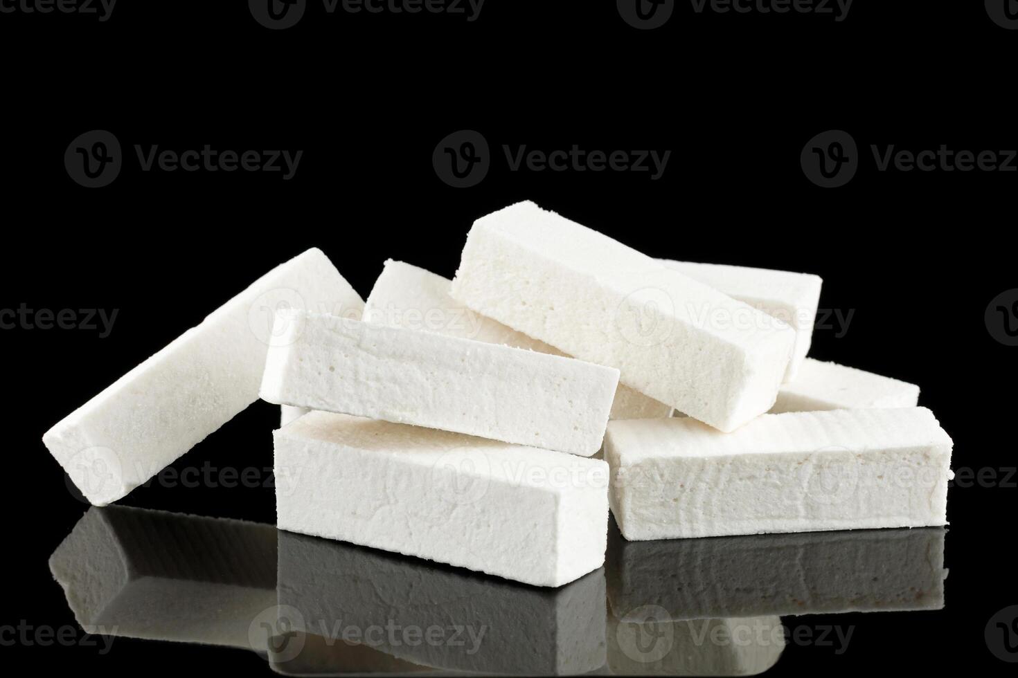 Pastilla white confectionery product on black. photo