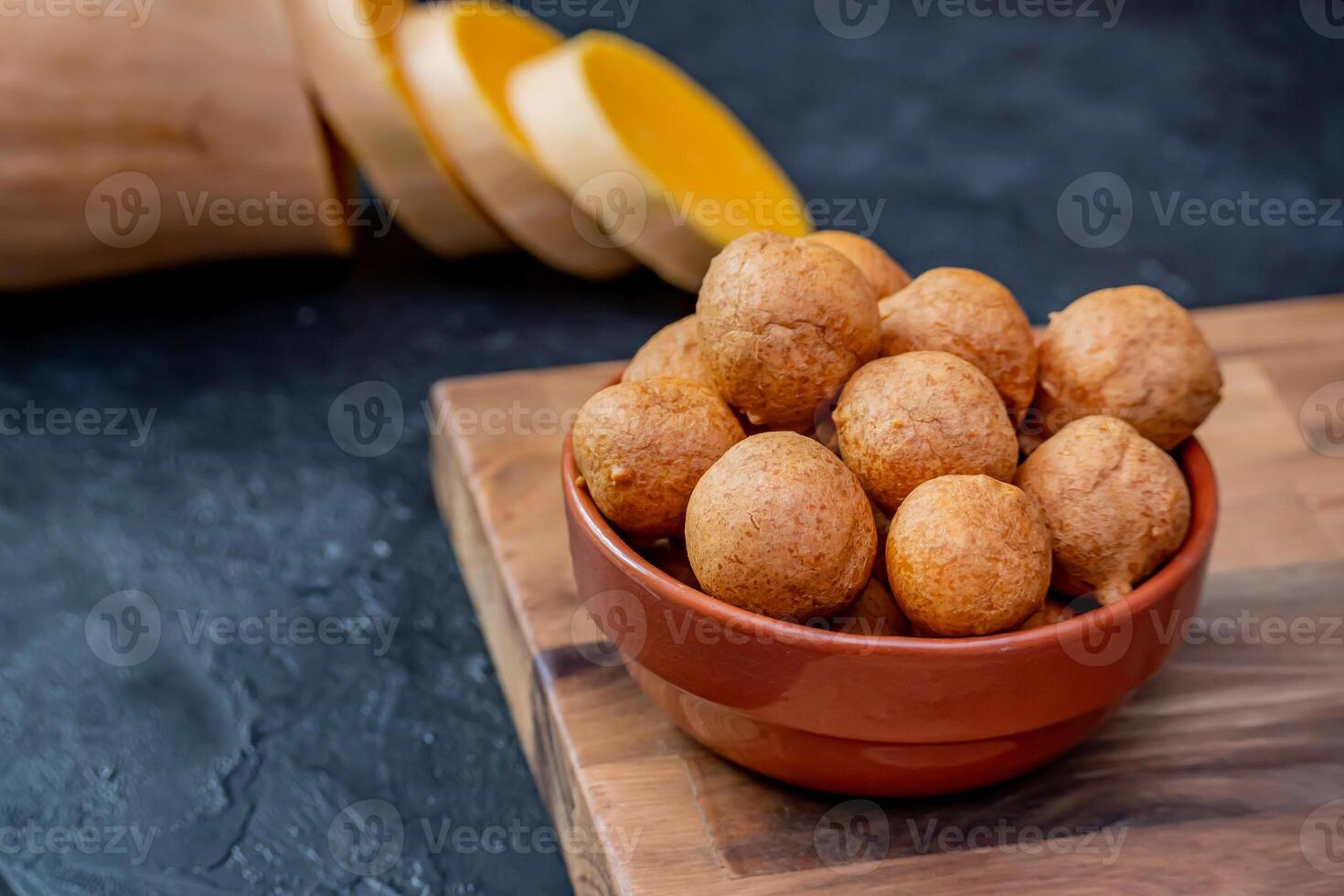Freshly cooked pumpkin fritters on a table. photo