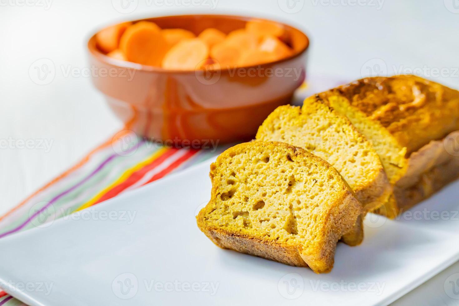 Carrot and cinnamon cake. Deep orange pastel on a light background. photo