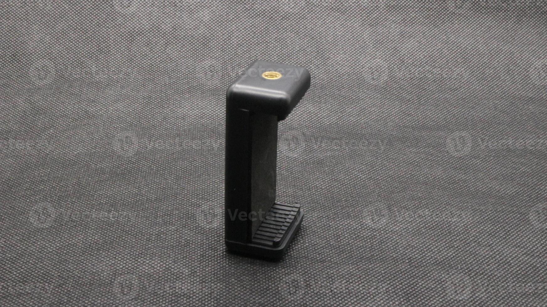 Tripod U holder for smart phone and camera isolated photo