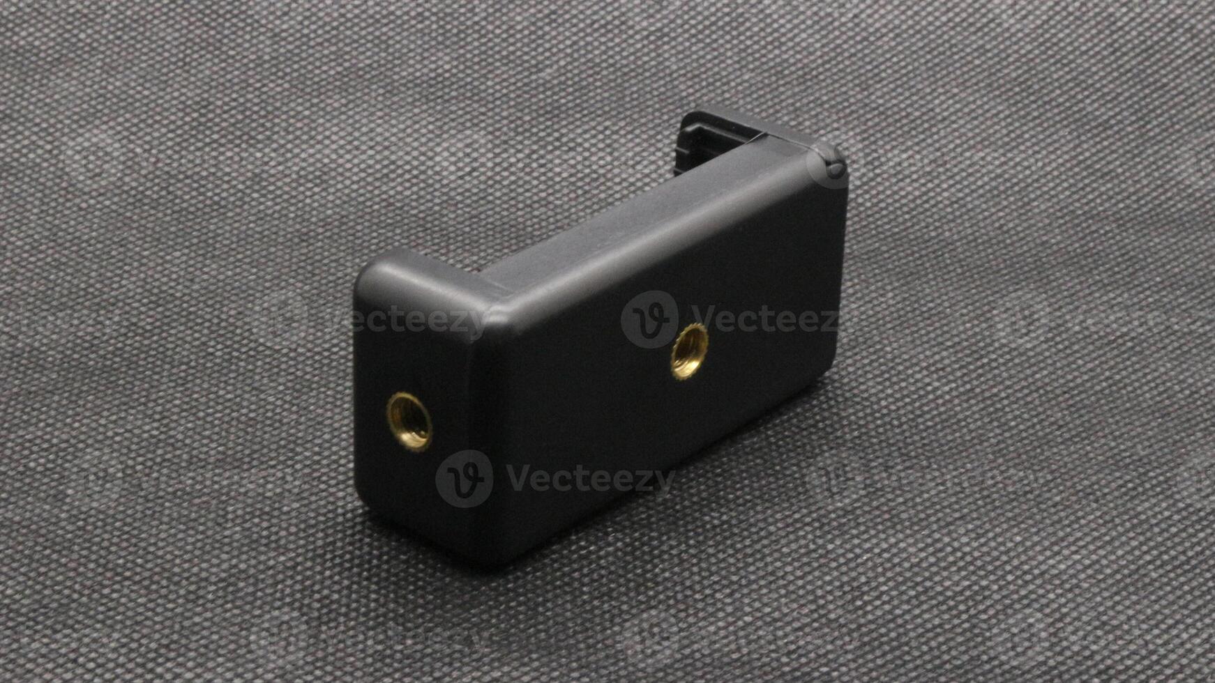 Tripod U holder for smart phone and camera isolated photo