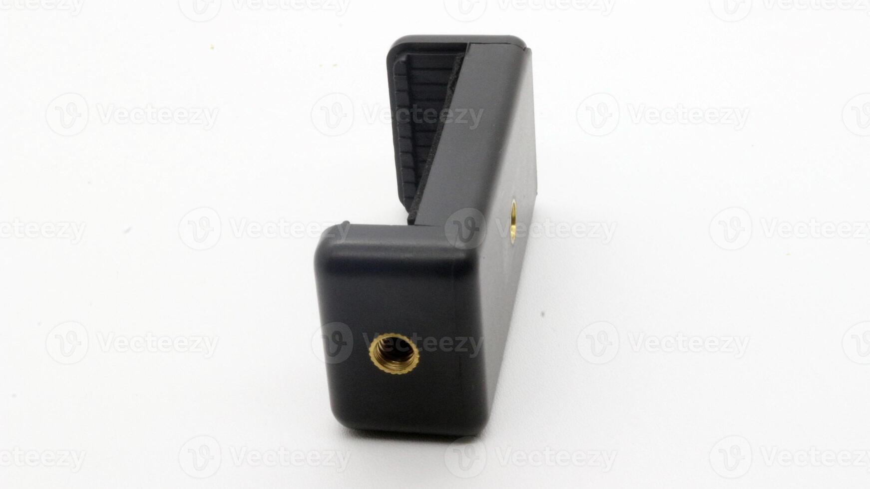 Tripod U holder for smart phone and camera isolated photo